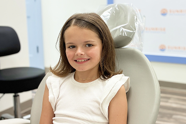 Smiling child in the treatment chair at Sunrise Orthodontics