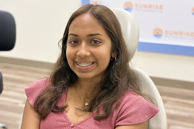 Smiling teen with braces at Sunrise Orthodontics